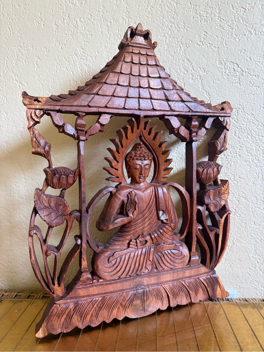 hand-carved panel is a "Solemn Buddha" relief sculpture from suar wood Bali